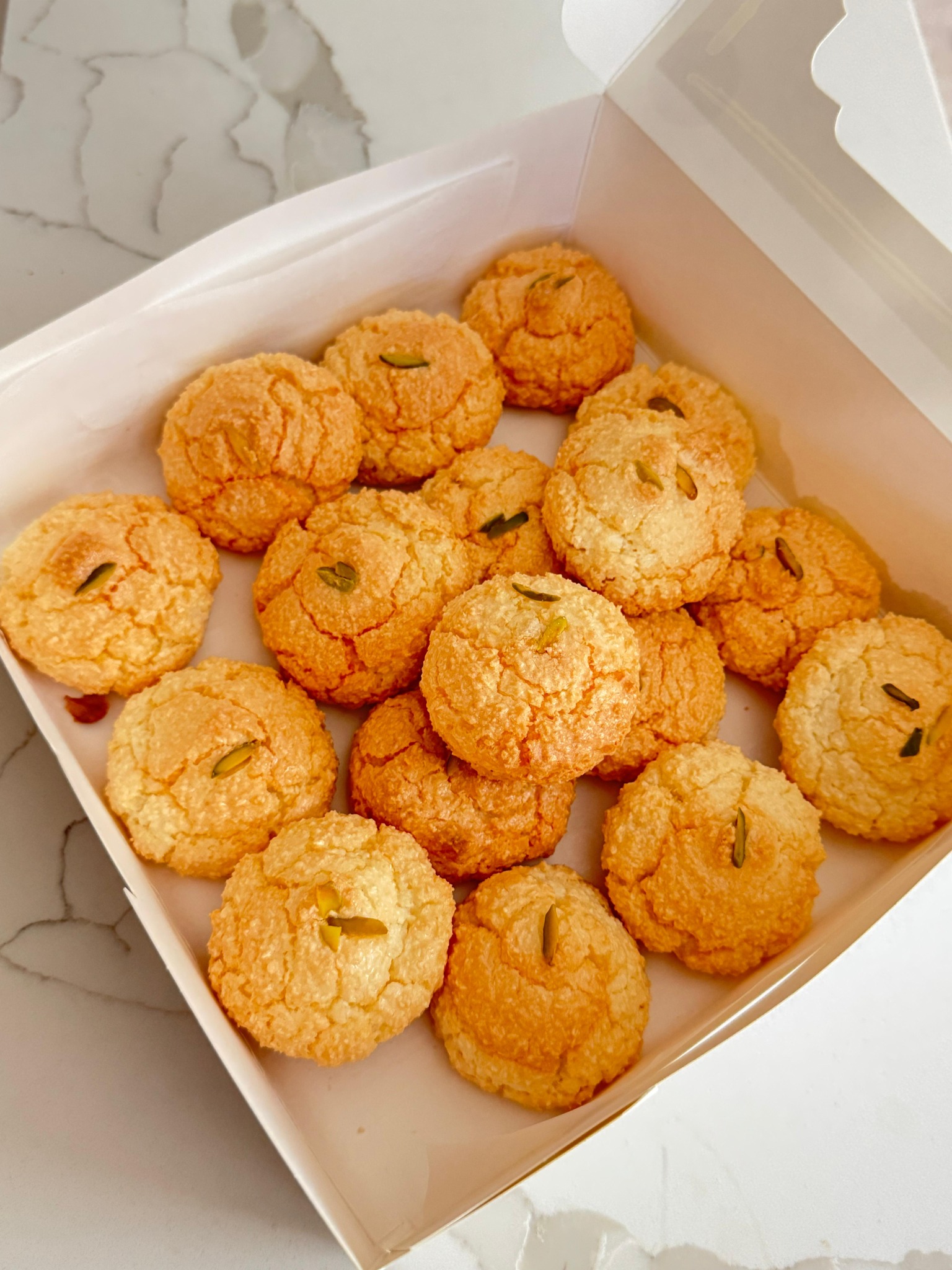 Fresh pistachio cookies in a bakery box