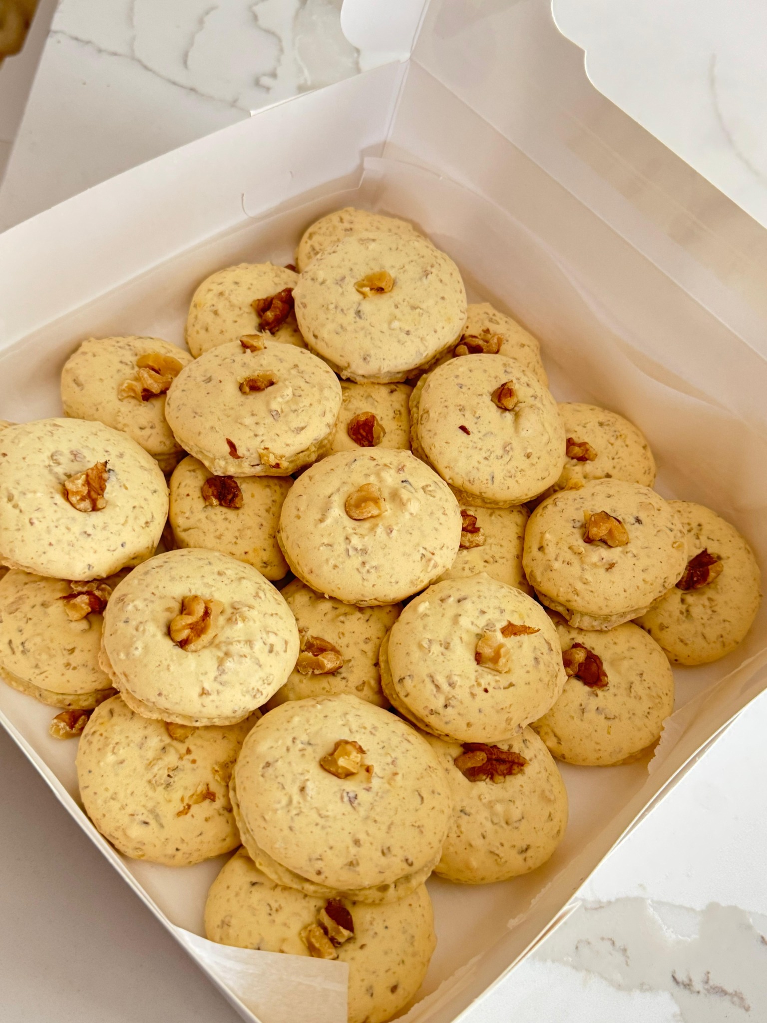 Fresh walnut cookies in a bakery box